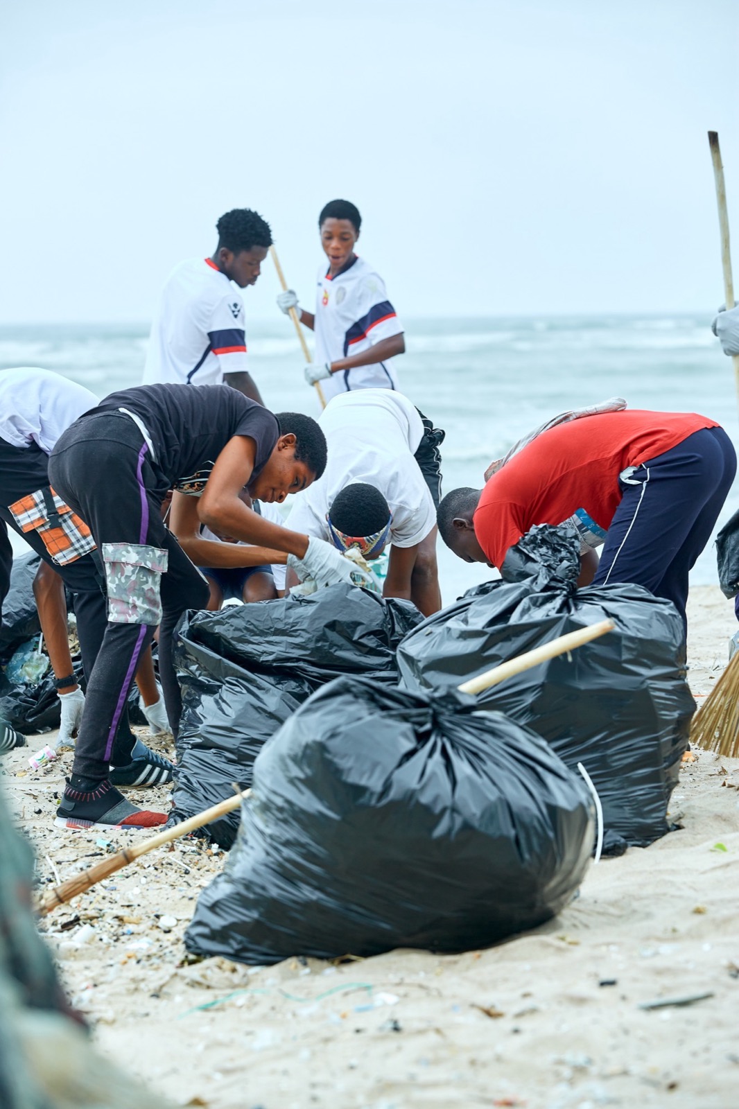 Volunteers clearing plastic waste from a shoreline